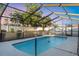 A relaxing in-ground pool inside a screened enclosure and surrounded by a patio at 2207 Holyoke Ave, Bradenton, FL 34207