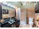 Updated bathroom with tiled shower, glass vanity, and neutral color palette at 2409 Gun Flint Trl, Palm Harbor, FL 34683
