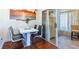 Modern dining area with seating for four and sliding glass doors to sun room at 2409 Gun Flint Trl, Palm Harbor, FL 34683