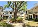Charming townhouse community features mature landscaping and a welcoming outdoor seating area at 2409 Gun Flint Trl, Palm Harbor, FL 34683