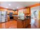 Spacious kitchen features stainless steel appliances, center island, and warm wood cabinetry at 2409 Gun Flint Trl, Palm Harbor, FL 34683
