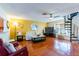 Spacious living room with hardwood floors, spiral staircase, and lots of natural light at 2409 Gun Flint Trl, Palm Harbor, FL 34683