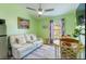 Comfortable living room with cozy seating, bright green walls and natural light at 2409 Gun Flint Trl, Palm Harbor, FL 34683