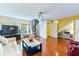 Spacious living room with hardwood floors, spiral staircase, and lots of natural light at 2409 Gun Flint Trl, Palm Harbor, FL 34683