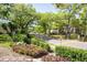 Scenic neighborhood street with lush greenery and mature trees at 2409 Gun Flint Trl, Palm Harbor, FL 34683