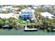 Waterfront estate featuring a pool, cabana, and private boat dock, offering a luxurious outdoor lifestyle at 244 Willow Ave, Anna Maria, FL 34216