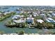 A prime waterfront property features a private dock, a beautiful pool area, and lush tropical landscaping at 244 Willow Ave, Anna Maria, FL 34216