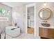 Bright bathroom features a soaking tub and marble tiling, adjacent to a walk in closet at 244 Willow Ave, Anna Maria, FL 34216