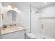Contemporary bathroom with a glass shower, marble countertop and patterned tile floor at 244 Willow Ave, Anna Maria, FL 34216