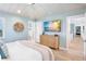 Airy bedroom with vaulted ceilings, TV, and doorway to hallway at 244 Willow Ave, Anna Maria, FL 34216