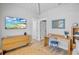 Bright bedroom with vaulted ceiling, desk, and beachfront TV view at 244 Willow Ave, Anna Maria, FL 34216