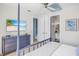 Beautiful bedroom features a four-poster bed, TV, built-ins and ensuite bathroom at 244 Willow Ave, Anna Maria, FL 34216