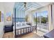 Beautiful bedroom featuring a four-poster bed, blue ceiling detail and private balcony at 244 Willow Ave, Anna Maria, FL 34216