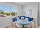 Cozy dining nook features built-in bench seating, decorative pillows, and natural light at 244 Willow Ave, Anna Maria, FL 34216