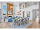 Bright dining room with seating for eight, open to a living area with a fireplace at 244 Willow Ave, Anna Maria, FL 34216