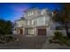 Stunning three-story home with a paver driveway, and multiple balconies and garages at 244 Willow Ave, Anna Maria, FL 34216