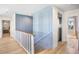 Light-filled hallway featuring an elevator, staircase, and view into a bedroom at 244 Willow Ave, Anna Maria, FL 34216
