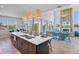 Open concept kitchen features a large center island, pendant lighting and a spacious dining area at 244 Willow Ave, Anna Maria, FL 34216