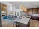 Open concept kitchen features a large center island, pendant lighting and an inviting dining area at 244 Willow Ave, Anna Maria, FL 34216