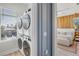 Convenient laundry room features stacked washer and dryer, and easy access to primary bedroom at 244 Willow Ave, Anna Maria, FL 34216