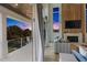 Balcony view from a living room, showcasing outdoor scenery and indoor elegance with a fireplace at 244 Willow Ave, Anna Maria, FL 34216