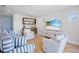Cozy living room featuring a built-in bar, comfortable seating and lots of natural light at 244 Willow Ave, Anna Maria, FL 34216