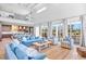 Open-concept living space with floor-to-ceiling windows, seamlessly connecting to the kitchen and dining areas at 244 Willow Ave, Anna Maria, FL 34216