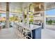 Entertain in this great outdoor kitchen with a large island and seating with a beautiful water view at 244 Willow Ave, Anna Maria, FL 34216