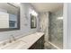 Bathroom featuring double sinks, marble countertops, and beautifully tiled walk-in shower at 3009 Live Oak Ln # 33, Palmetto, FL 34221
