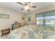Bedroom featuring a ceiling fan, windows, dresser, and bench at 3009 Live Oak Ln # 33, Palmetto, FL 34221