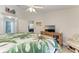 Bright bedroom featuring a ceiling fan, light wood dresser, and tropical themed bedding at 3009 Live Oak Ln # 33, Palmetto, FL 34221