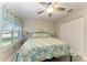 Bedroom featuring a ceiling fan, windows, and large closet at 3009 Live Oak Ln # 33, Palmetto, FL 34221