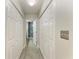 Hallway with tile floor and white closet doors leading to the en-suite bathroom at 3009 Live Oak Ln # 33, Palmetto, FL 34221