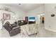 Bright living room with vaulted ceiling, ceiling fan, tile flooring and comfortable seating arrangement at 3009 Live Oak Ln # 33, Palmetto, FL 34221