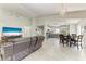 Open-concept living space featuring a tv, tile flooring, and seamless flow to the kitchen and dining area at 3009 Live Oak Ln # 33, Palmetto, FL 34221