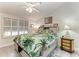 Bright main bedroom featuring shuttered windows, neutral walls, and a tropical-themed bedspread at 3009 Live Oak Ln # 33, Palmetto, FL 34221