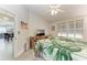 Bright main bedroom featuring shuttered windows, neutral walls, and a view to the kitchen at 3009 Live Oak Ln # 33, Palmetto, FL 34221