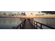 Calm sunset at the end of a long wooden pier overlooking a tranquil body of water at 3009 Live Oak Ln # 33, Palmetto, FL 34221