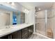 Modern bathroom featuring double sinks, granite countertops, and a glass-enclosed shower with a built-in bench at 3126 58Th E Way, Palmetto, FL 34221