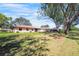 Expansive backyard featuring a large, grassy area and mature trees, perfect for outdoor activities at 314 Signorelli Dr, Nokomis, FL 34275