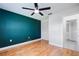 Bedroom with hardwood floors, a ceiling fan, and spacious closet at 314 Signorelli Dr, Nokomis, FL 34275