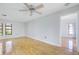 Bedroom with wood floors, ceiling fan, neutral walls, and natural light from the windows at 314 Signorelli Dr, Nokomis, FL 34275