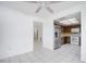 Spacious dining area features tile flooring, a ceiling fan, and adjacent kitchen at 314 Signorelli Dr, Nokomis, FL 34275