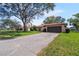 Exterior of a home with a well-maintained lawn, long driveway, mature trees, and a two-car garage at 314 Signorelli Dr, Nokomis, FL 34275