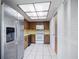 Kitchen includes wood cabinets, white appliances, tile flooring, and skylight at 314 Signorelli Dr, Nokomis, FL 34275