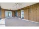 Enclosed lanai with tile floors, ceiling fan, and wood paneling, providing a versatile space at 314 Signorelli Dr, Nokomis, FL 34275
