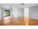 Bright living room with wood floors, neutral walls, ceiling fan, and glass doors leading to an enclosed patio at 314 Signorelli Dr, Nokomis, FL 34275