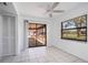 Bright room with tiled flooring, ceiling fan, and sliding door to a screened patio at 314 Signorelli Dr, Nokomis, FL 34275