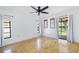 Bedroom with hardwood floors, neutral walls, natural light, and a sliding glass door to the patio at 314 Signorelli Dr, Nokomis, FL 34275