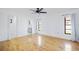 Bright main bedroom with hardwood floors, ceiling fan, walk in closet, and natural light from windows at 314 Signorelli Dr, Nokomis, FL 34275